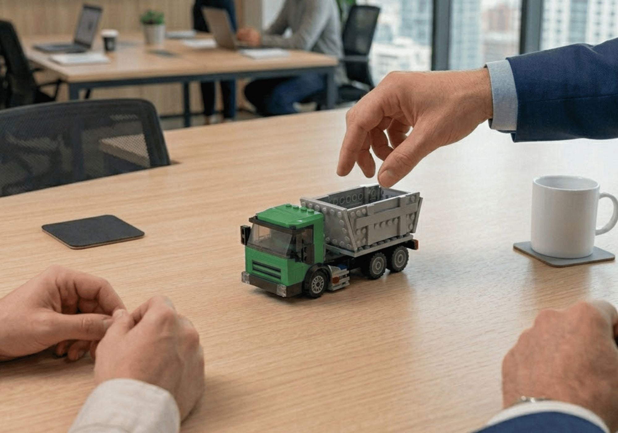 A small green and gray custom LEGO set dump truck 